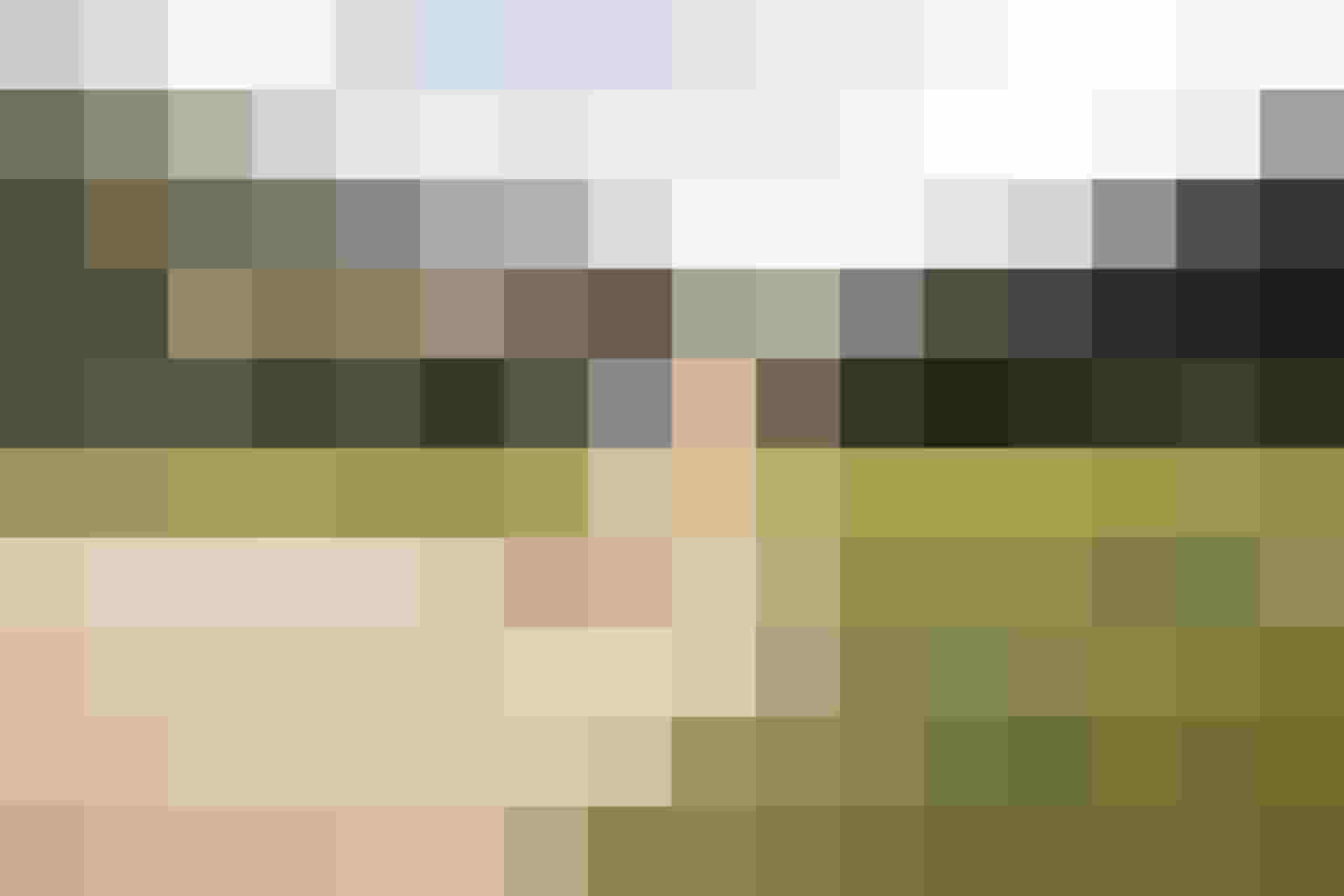 Golfer Plays Bunker Shot against an Alpine Backdrop in Bad Hofgastein at the Nature Hotel.